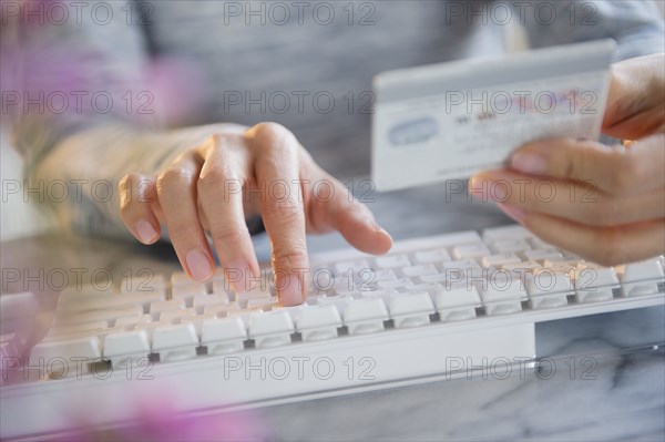 Mixed race woman shopping online with credit card