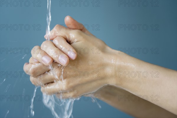 Close up of mixed race woman washing her hands