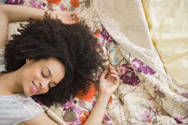 Mixed race woman laying on bed