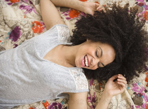 Mixed race woman laying on bed