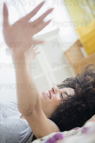 Mixed race woman laying on bed