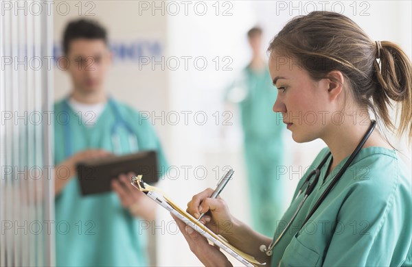 Doctor writing notes in hospital emergency room