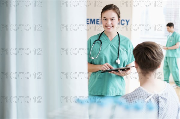 Doctor talking to patient in hospital emergency room