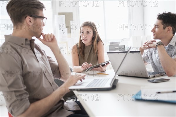 Business people using technology in office meeting