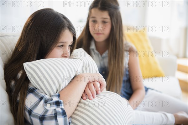 Caucasian girl comforting twin sister