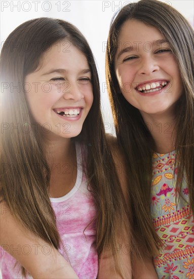 Caucasian twin sisters smiling