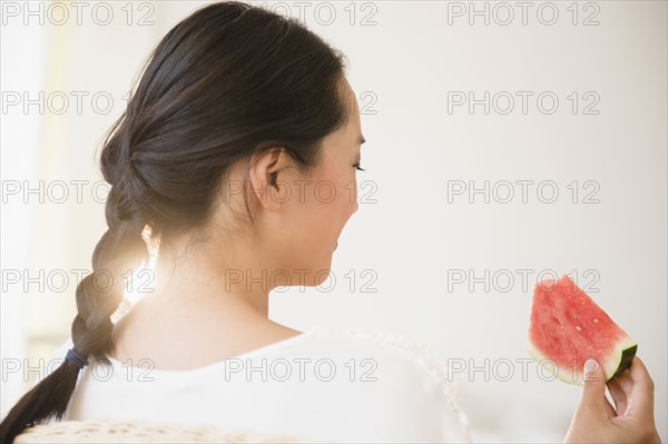 Chinese woman eating watermelon