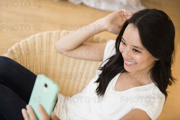 Chinese woman taking selfie with cell phone