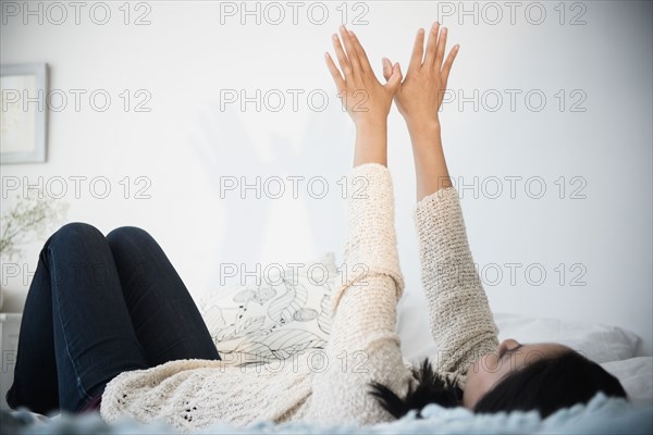 Chinese woman making shadow puppet