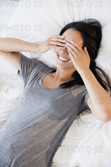 Chinese woman covering her eyes