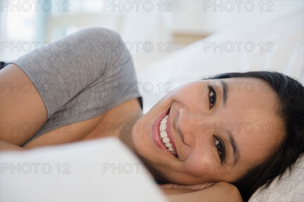 Chinese woman laying on bed