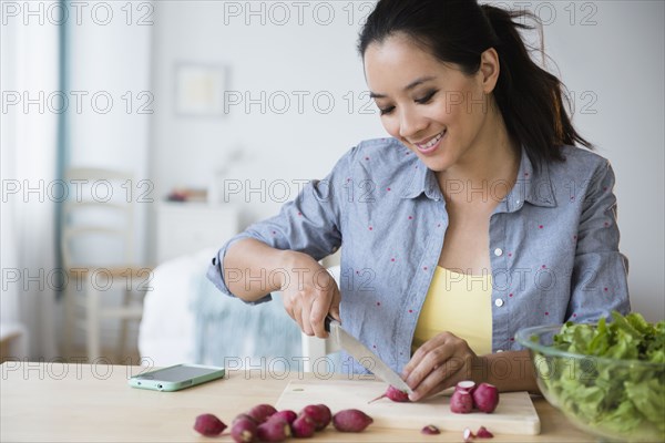 Chinese woman preparing salad