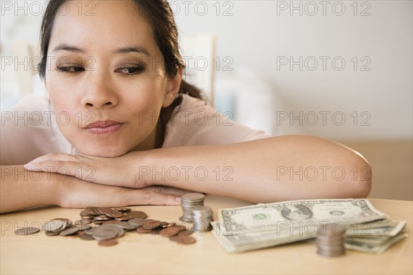 Chinese woman contemplating finances
