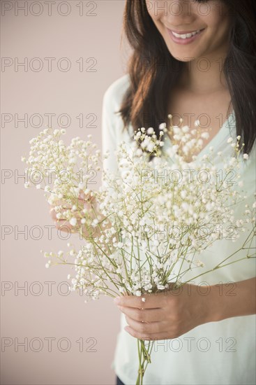 Chinese woman holding bunch of flowers