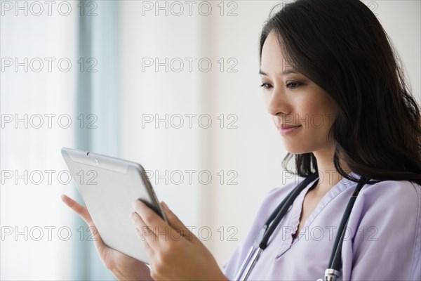 Chinese nurse using digital tablet