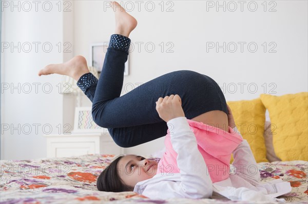 Girl playing on bed