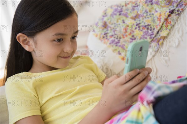 Smiling girl using cell phone