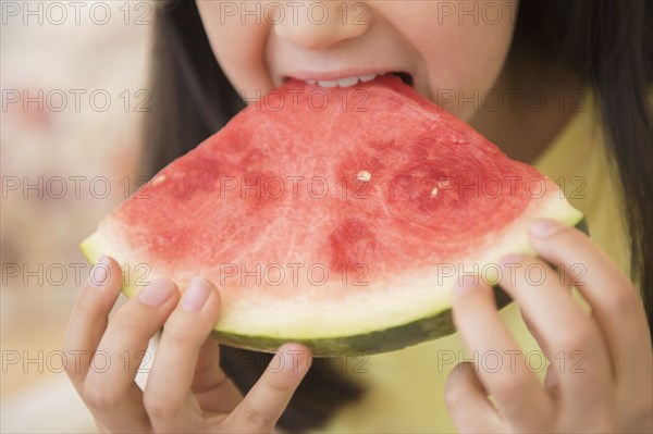 Close up of girl eating watermelon
