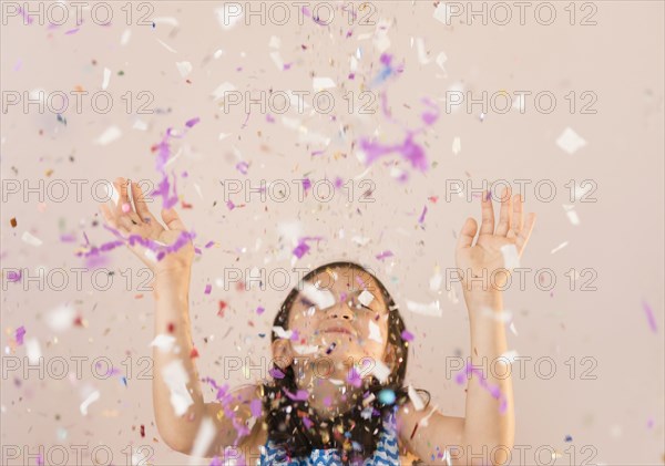 Girl tossing confetti in air