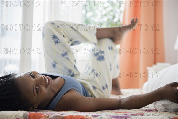Black woman laying on bed