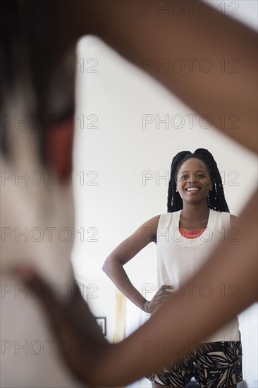 Black woman admiring herself in mirror