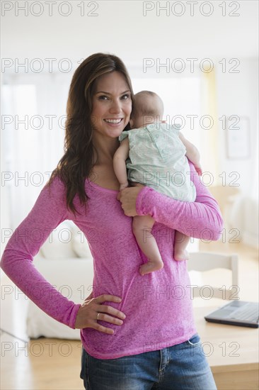 Mother holding baby daughter