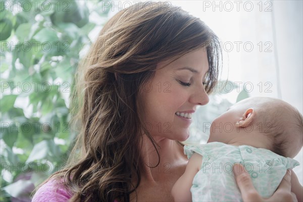 Mother holding baby daughter