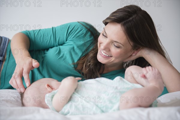 Mother playing with baby daughter