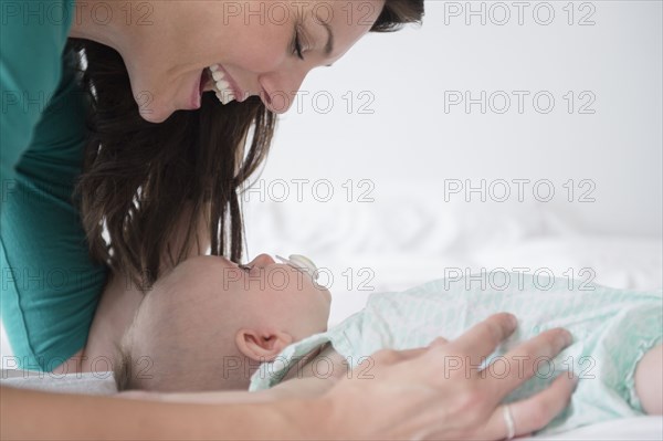 Mother playing with baby daughter