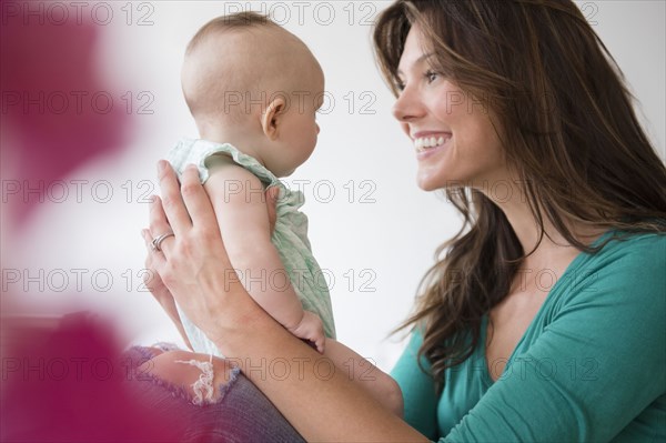 Mother holding baby daughter