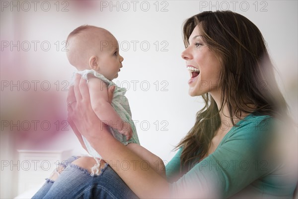 Mother holding baby daughter