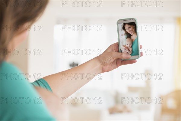 Mother taking selfie with baby daughter