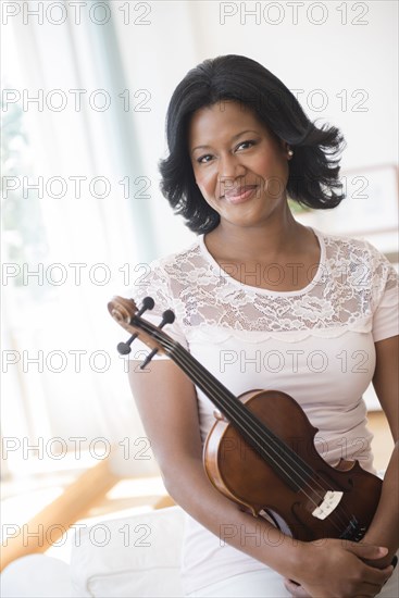 Black woman holding violin