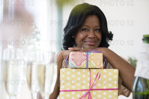 Black woman with gifts at party