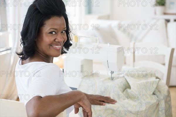 Black woman using sewing machine