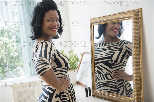 Black woman smiling near mirror