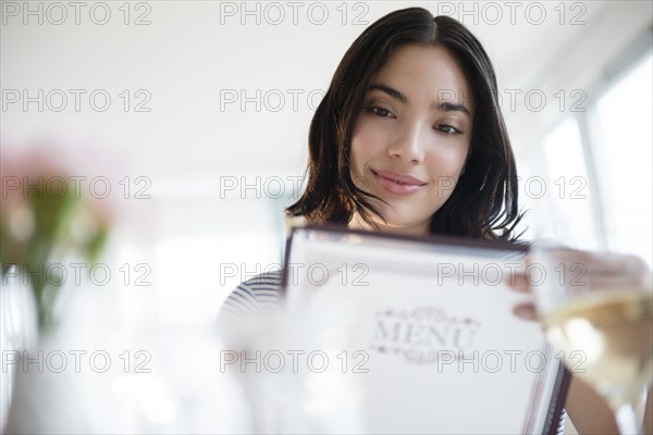 Hispanic woman reading menu
