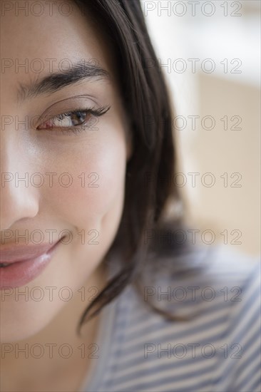 Close up of face of smiling Hispanic woman