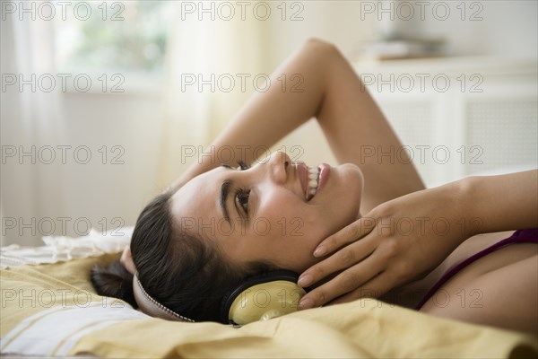 Hispanic woman listening to headphones