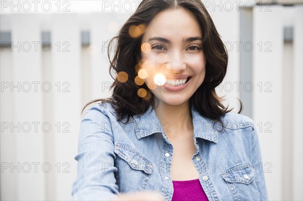 Hispanic woman holding sparkler