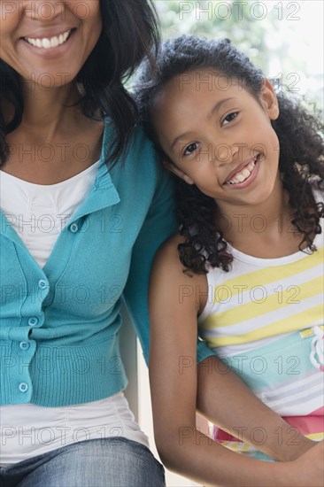 Mother and daughter smiling