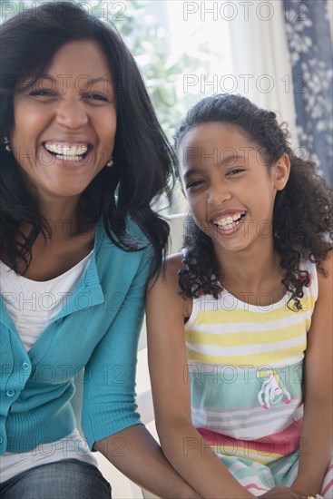 Mother and daughter smiling