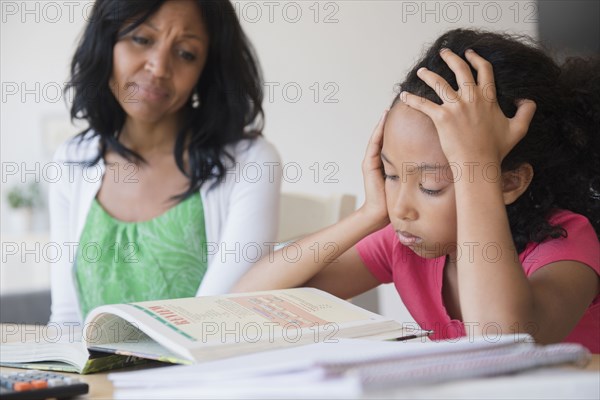 Mother helping daughter with homework