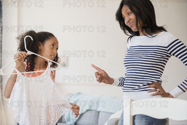 Mother disapproving shirt of daughter