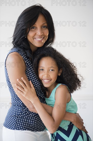 Mother and daughter hugging