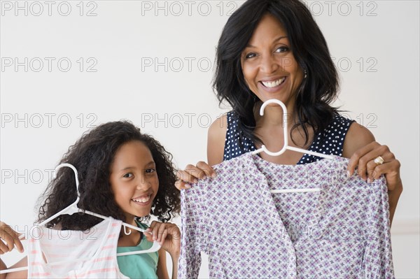 Mother and daughter displaying clothing