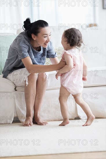 Mother and baby daughter in living room