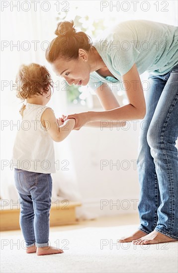 Mother comforting baby daughter