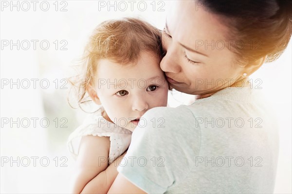 Mother holding baby daughter