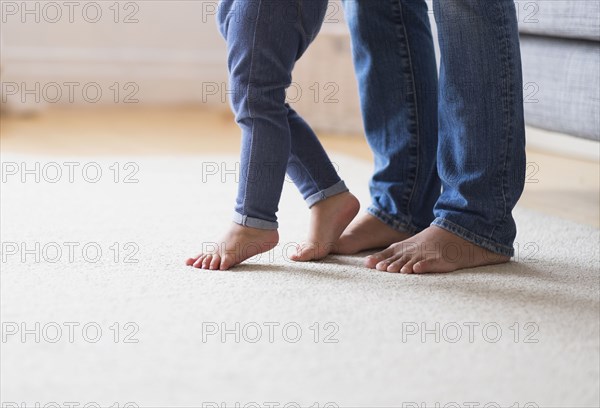 Mother and baby daughter with bare feet